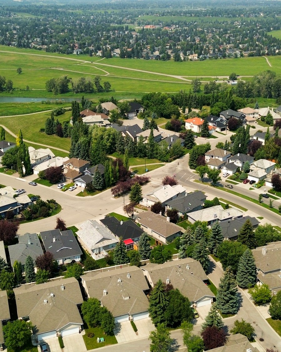 Same neighborhood, wide establishing view toward the river pathway